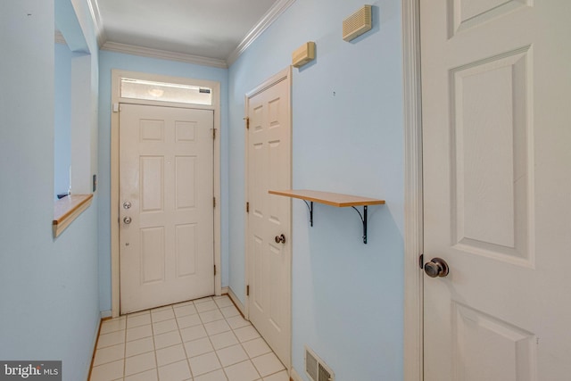 doorway featuring visible vents, ornamental molding, and light tile patterned floors