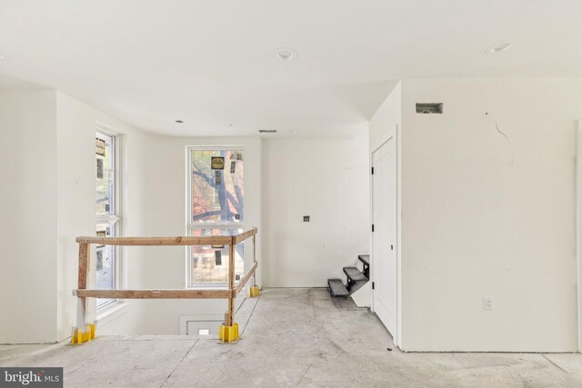 unfurnished room featuring unfinished concrete flooring