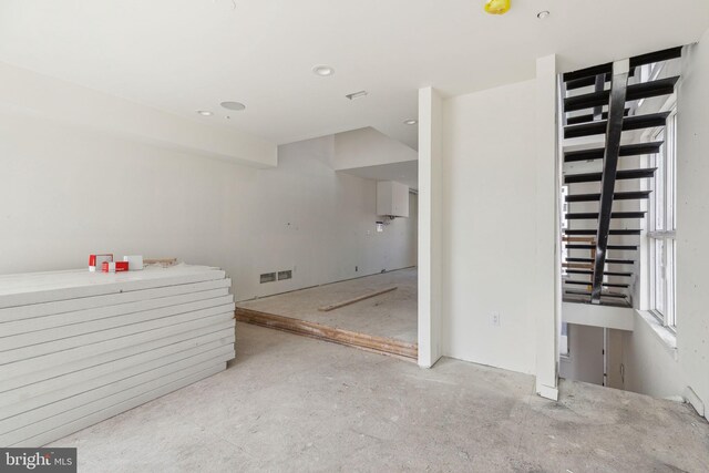 interior space with concrete floors, visible vents, and recessed lighting