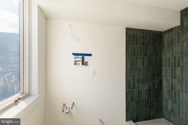 bathroom with tiled shower