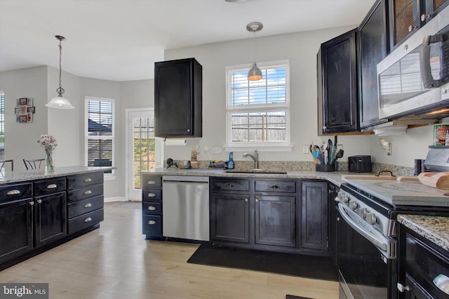 1425 Wanda Dr, Hanover, PA 17331 - kitchen with light stone countertops, appliances with stainless steel finishes, a sink, dark cabinets, and light wood-style flooring
