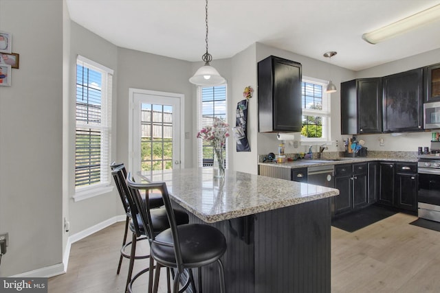 1425 Wanda Dr, Hanover, PA 17331 - kitchen featuring appliances with stainless steel finishes, plenty of natural light, light stone counters, and light wood-type flooring
