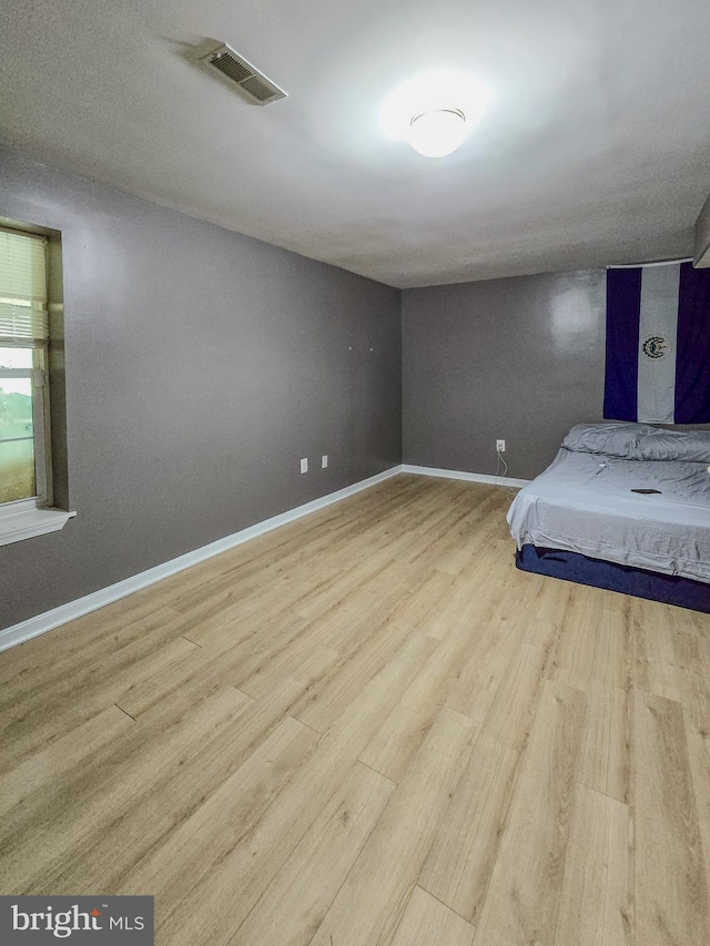 17616 Chisholm Ln, Dumfries, VA 22026 - unfurnished bedroom featuring wood finished floors and baseboards
