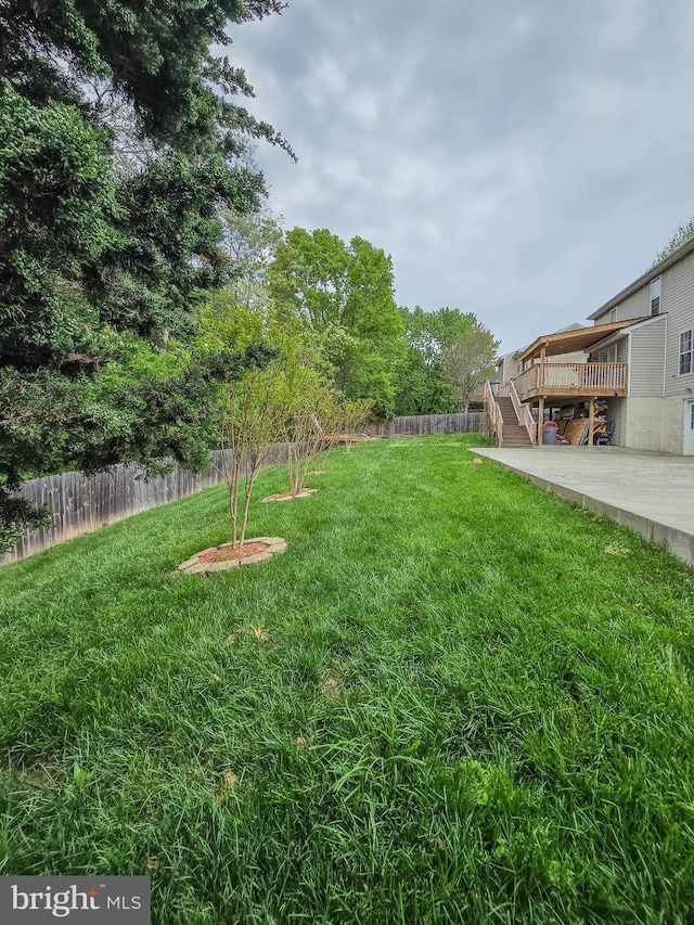 17616 Chisholm Ln, Dumfries, VA 22026 - view of yard featuring stairs, a wooden deck, and a patio area