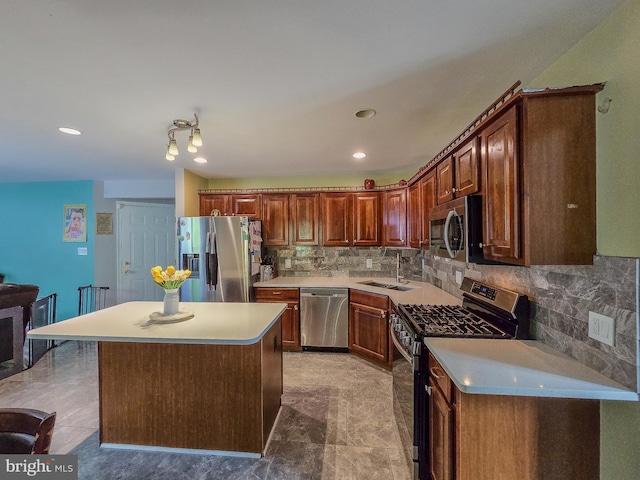 17616 Chisholm Ln, Dumfries, VA 22026 - kitchen featuring stainless steel appliances, a sink, light countertops, backsplash, and a center island