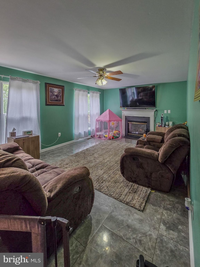 17616 Chisholm Ln, Dumfries, VA 22026 - living area featuring healthy amount of natural light, a glass covered fireplace, and ceiling fan