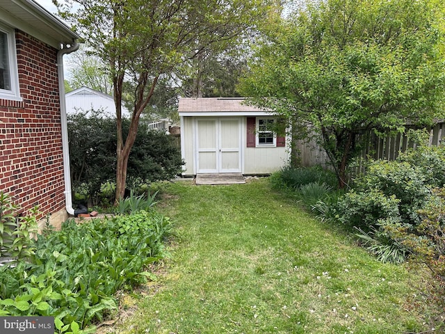 view of grassy yard featuring a storage unit and an outdoor structure