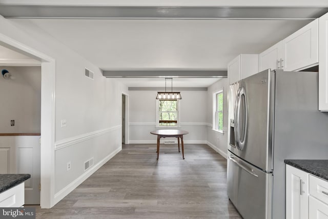 kitchen with white cabinetry, visible vents, stainless steel fridge with ice dispenser, and light wood-type flooring