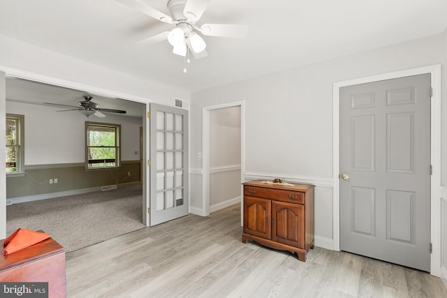 interior space featuring baseboards, light wood-style flooring, and visible vents