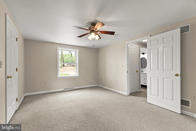 unfurnished bedroom with baseboards, carpet, connected bathroom, and visible vents