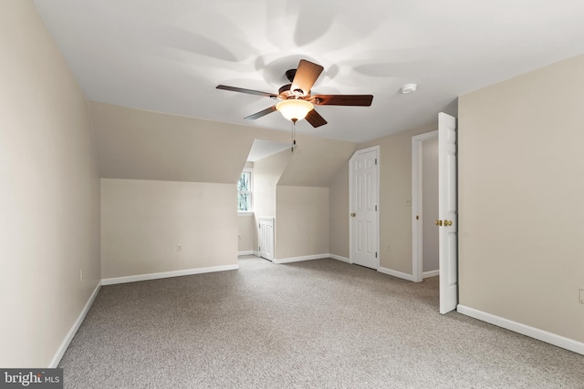 bonus room featuring baseboards, ceiling fan, carpet flooring, and lofted ceiling