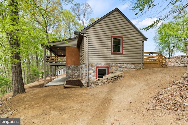 view of property exterior with a wooden deck