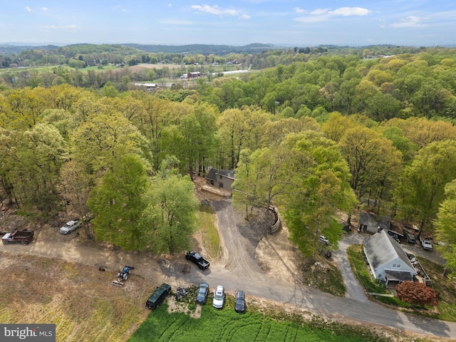 drone / aerial view featuring a forest view