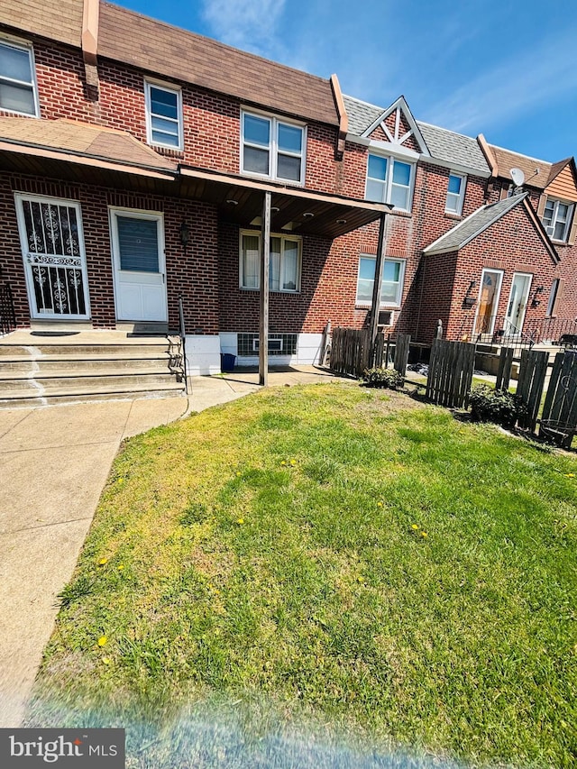 2633 Levick St, Philadelphia, PA 19149 - rear view of house with brick siding, a lawn, and fence