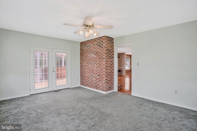 unfurnished living room featuring a healthy amount of sunlight, french doors, ceiling fan, and carpet