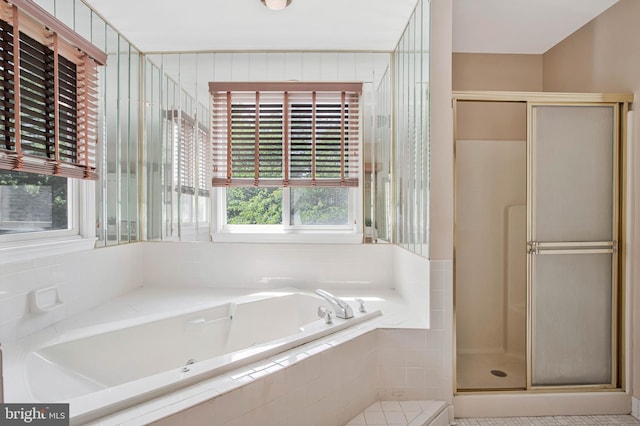 full bathroom featuring a bath and a stall shower