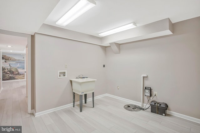 laundry room featuring baseboards, light wood finished floors, washer hookup, hookup for an electric dryer, and laundry area