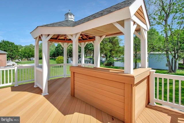 wooden terrace with a yard and a gazebo
