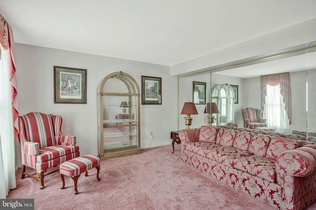carpeted living area featuring baseboards