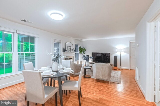 1541 Church Hill Pl Unit 1541, Reston, VA 20194 - dining room with a fireplace, baseboards, visible vents, and light wood-style floors
