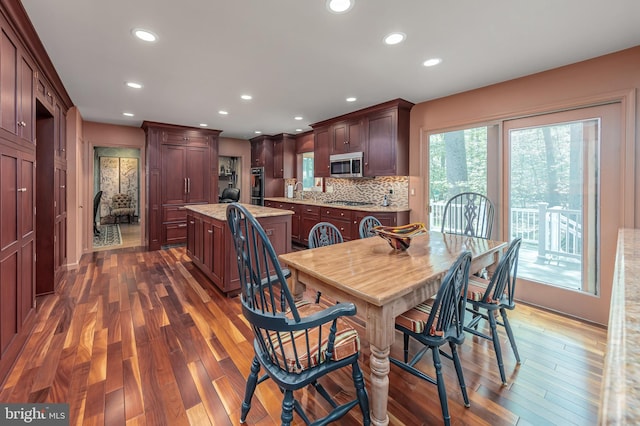 dining space featuring dark wood-style flooring and recessed lighting