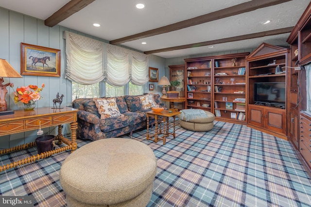 carpeted living area featuring beam ceiling, recessed lighting, and a decorative wall