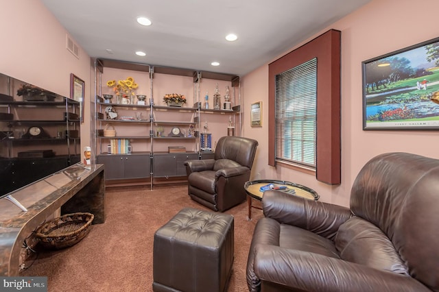 sitting room with visible vents, recessed lighting, and carpet flooring