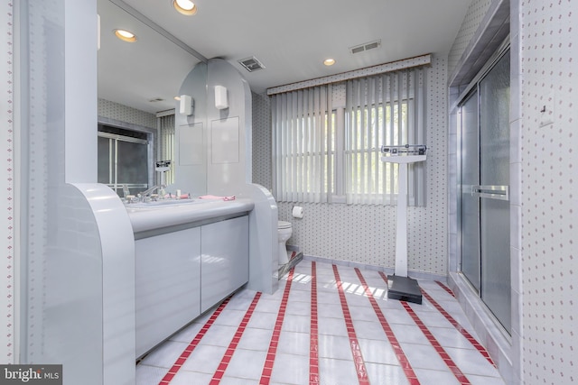 bathroom featuring visible vents, a stall shower, and toilet