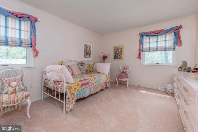 bedroom featuring carpet flooring, multiple windows, baseboards, and visible vents