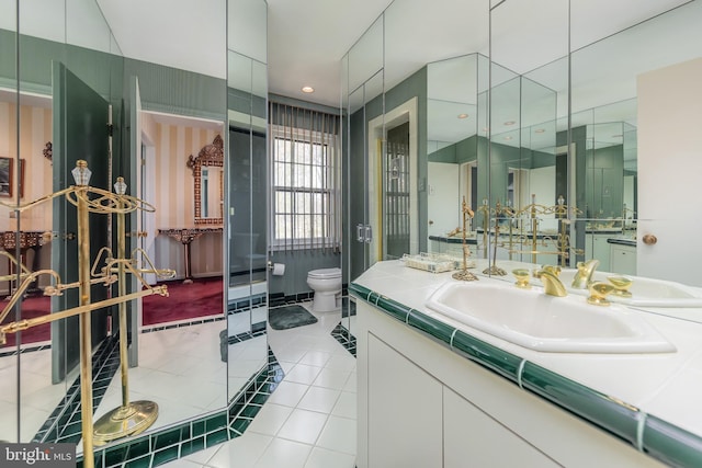 bathroom with toilet, tile patterned flooring, and vanity