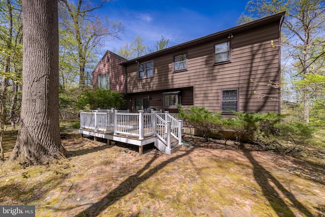 rear view of property featuring a deck