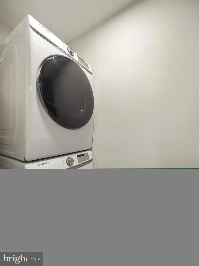 317 Homeland Southway Unit 1A, Baltimore, MD 21212 - clothes washing area featuring stacked washer and clothes dryer