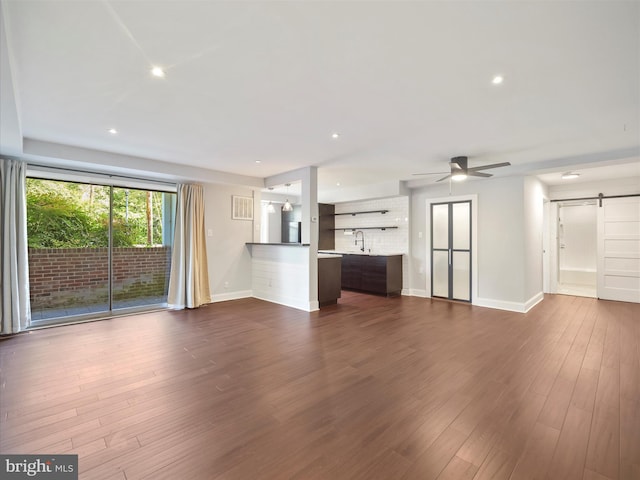 317 Homeland Southway Unit 1A, Baltimore, MD 21212 - unfurnished living room with a barn door, baseboards, dark wood-style flooring, ceiling fan, and recessed lighting