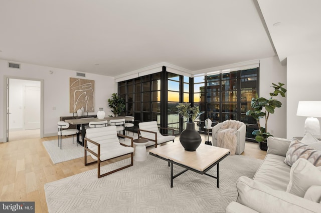 living room featuring wood finished floors and floor to ceiling windows