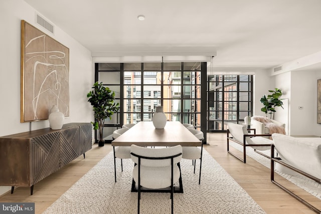 office featuring floor to ceiling windows and light wood-type flooring