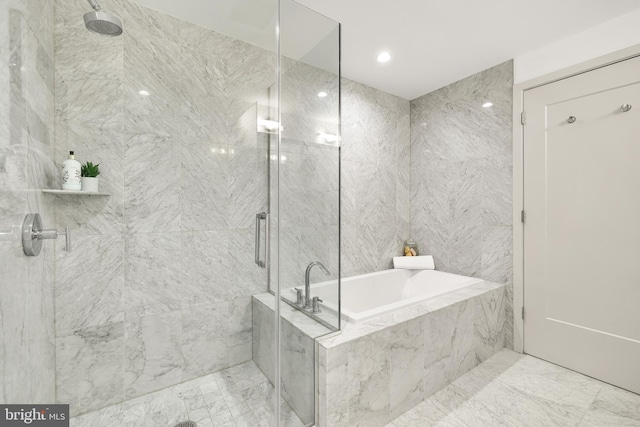bathroom with a stall shower and a bath