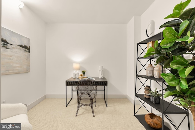 carpeted office featuring baseboards