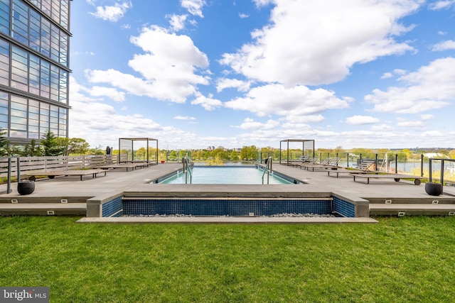 community pool with a yard and a wooden deck