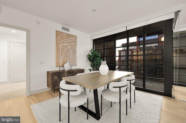 dining room featuring wood finished floors and baseboards