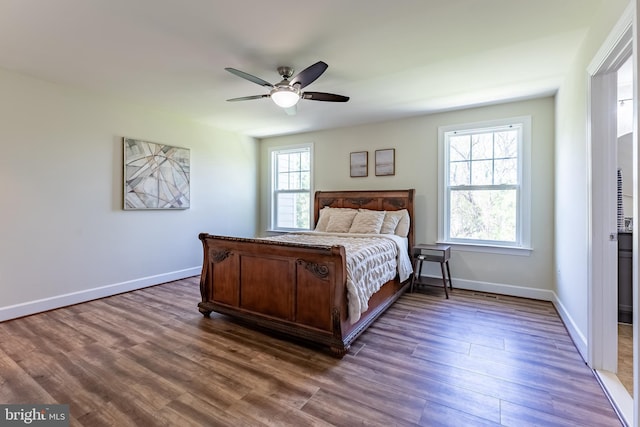 bedroom featuring dark wood-type flooring, baseboards, and ceiling fan