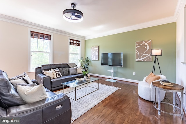 living area featuring baseboards, ornamental molding, and dark wood finished floors