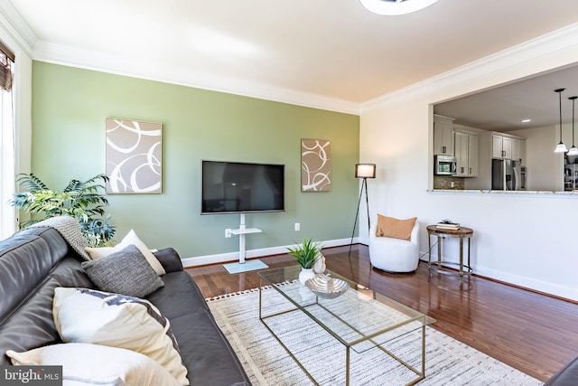 living room featuring baseboards, ornamental molding, and dark wood finished floors