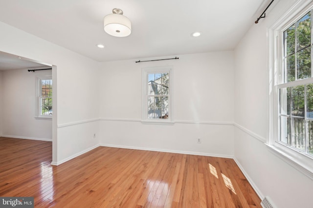 unfurnished room with recessed lighting, baseboards, and light wood-style floors