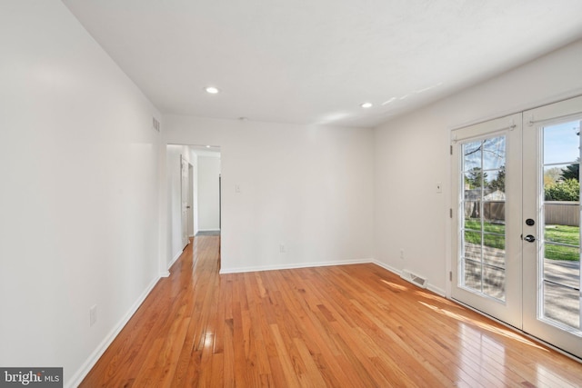 unfurnished room featuring french doors, recessed lighting, light wood-style flooring, and baseboards