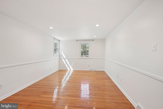 empty room featuring recessed lighting, visible vents, baseboards, and light wood-type flooring