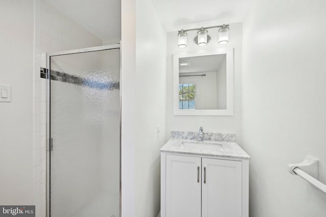 full bathroom featuring a shower stall and vanity