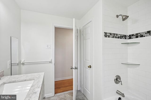 full bathroom featuring baseboards, vanity, and shower / bathing tub combination