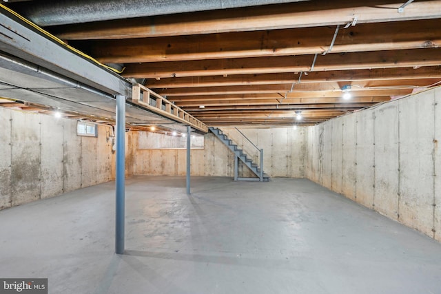 unfinished basement featuring stairway