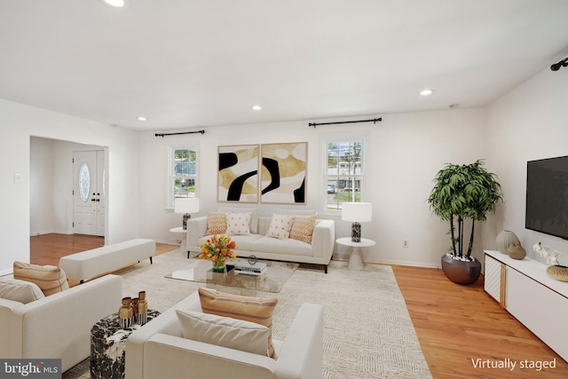 living area with recessed lighting, light wood-style floors, and plenty of natural light