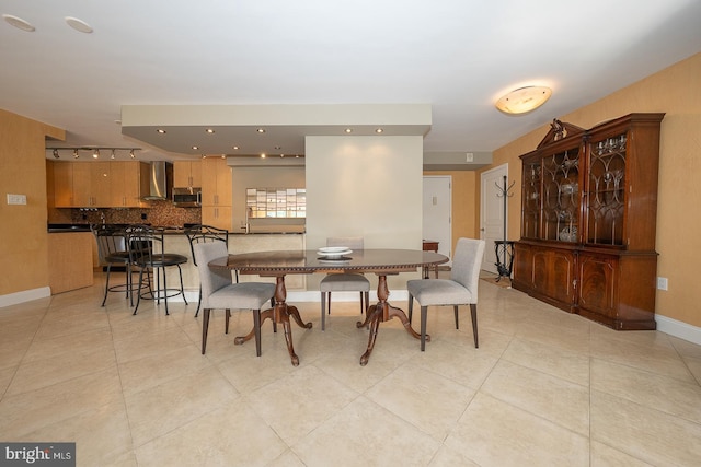 dining room featuring light tile patterned floors and baseboards